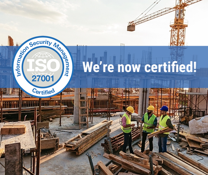 A social graphic over a photograph of a concrete-frame construction site with a tower crane, three workers in hard hats and high-visibility vests conferring beside stacked timber, and a circular ISO 27001 Information Security Management certification badge beside the words We are now certified